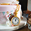 decorated with edible pocket watch, playing cards, bunting and flowers